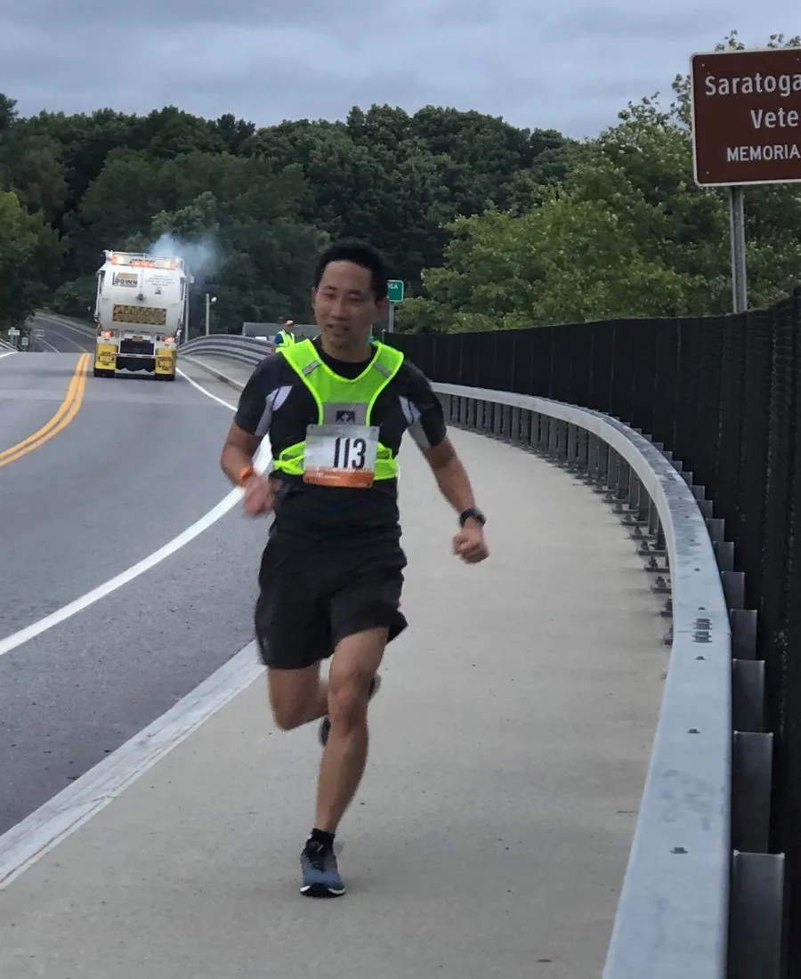 Ed running a race across a bridge